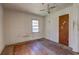 Bedroom featuring hardwood floors, ceiling fan, and natural light from the window at 118 Ingleside Dr, Jonesboro, GA 30236