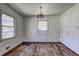 Image shows a dining room featuring a light fixture, wood flooring, and natural light at 118 Ingleside Dr, Jonesboro, GA 30236