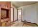 Empty room showing damaged walls and flooring, with doorways to other rooms at 118 Ingleside Dr, Jonesboro, GA 30236
