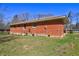 An exterior view of a one-story brick home with green grass in the front yard at 118 Ingleside Dr, Jonesboro, GA 30236