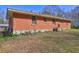 An exterior view of a brick home with a grassy lawn at 118 Ingleside Dr, Jonesboro, GA 30236
