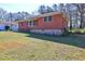 A charming one-story brick home with a well-maintained lawn, seen from an angle at 118 Ingleside Dr, Jonesboro, GA 30236