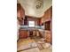 Outdated kitchen features damaged cabinets, flooring, and a window over the sink at 118 Ingleside Dr, Jonesboro, GA 30236