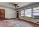 Image shows a living room featuring a ceiling fan and natural light at 118 Ingleside Dr, Jonesboro, GA 30236