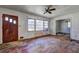Image shows a living room featuring a ceiling fan, wood flooring, and natural light at 118 Ingleside Dr, Jonesboro, GA 30236