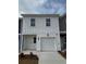 Charming two-story home featuring a one car garage, stylish white siding, and a well-maintained front yard at 1350 Riverstone Rd # 105, Jonesboro, GA 30238