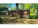 Backyard of brick home with mature trees and chain link fence at 1655 Tryon Rd, Atlanta, GA 30319