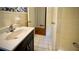 Tile bathroom with dark vanity and a view to an adjacent room at 1655 Tryon Rd, Atlanta, GA 30319