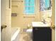 Traditional bathroom with a tiled shower and tub combination and navy vanity at 1655 Tryon Rd, Atlanta, GA 30319