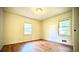 Bright bedroom with wood floors and natural light from the two windows at 1655 Tryon Rd, Atlanta, GA 30319