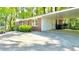 Brick ranch-style home featuring a convenient attached carport and tidy landscaping at 1655 Tryon Rd, Atlanta, GA 30319