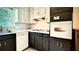 Kitchen with dark cabinets and white appliances at 1655 Tryon Rd, Atlanta, GA 30319
