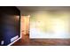 Living room featuring hardwood floors, blue accent wall and views to the hallway at 1655 Tryon Rd, Atlanta, GA 30319