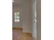 Inviting entryway with light hardwood floors, offering a glimpse through the glass front door at 1899 Deco Dr, Kennesaw, GA 30144