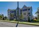 Townhome showing multi-tone siding and brick facade, front lawn and proximity to street at 1899 Deco Dr, Kennesaw, GA 30144