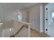 Second floor hallway with doors leading to bedrooms; natural light and wood floors at 1899 Deco Dr, Kennesaw, GA 30144