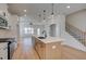 Elegant kitchen with center island, pendant lighting, stainless steel appliances, and access to the staircase at 1899 Deco Dr, Kennesaw, GA 30144