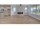 Bright living room with electric fireplace, large windows, and an open floor plan to kitchen at 1899 Deco Dr, Kennesaw, GA 30144