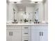 Beautiful bathroom featuring dual sinks, white cabinets, black hardware, and a large mirror at 625 Home Se Ave, Atlanta, GA 30312