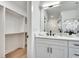 Bathroom featuring a vanity with dual sinks, white cabinets, marble countertop, and walk-in closet at 625 Home Se Ave, Atlanta, GA 30312