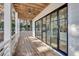 Lovely covered porch with wood flooring, modern ceiling fan and access via black framed sliding glass doors at 625 Home Se Ave, Atlanta, GA 30312