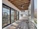Charming covered porch features wood flooring, modern ceiling fan and white pillars, ready for relaxing outside at 625 Home Se Ave, Atlanta, GA 30312