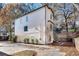 Side view of white two-story home with black framed windows, garage, and beautiful landscaping at 625 Home Se Ave, Atlanta, GA 30312