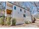 White two-story home with a balcony, white garage door, and tidy landscaping at 625 Home Se Ave, Atlanta, GA 30312