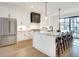 Modern white kitchen featuring stainless steel appliances, marble countertops, and island seating at 625 Home Se Ave, Atlanta, GA 30312
