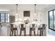 Bright kitchen with stainless steel appliances, white cabinets, an island, and modern pendant lighting at 625 Home Se Ave, Atlanta, GA 30312