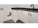 Functional laundry area with sleek white cabinets, dark countertops, and modern black hardware at 625 Home Se Ave, Atlanta, GA 30312