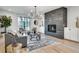 Cozy living room is designed with a modern fireplace and hardwood floors filled with comfortable furniture at 625 Home Se Ave, Atlanta, GA 30312