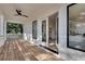 Inviting covered porch featuring wood flooring, white railings, ceiling fan, and a view to the interior at 625 Home Se Ave, Atlanta, GA 30312