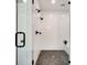 Elegant shower with subway tile, black fixtures, river rock floor, frameless glass door, and corner seat at 625 Home Se Ave, Atlanta, GA 30312