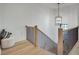 Upstairs hallway with wood staircase, iron railings, and overhead chandelier lighting at 625 Home Se Ave, Atlanta, GA 30312