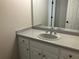Bathroom with white vanity, countertop, and sink, complemented by a well-lit mirror and hardware at 870 Thornberry Dr, Alpharetta, GA 30022