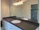 Bathroom featuring a dark countertop with dual sinks, complemented by ample counter space and a large mirror at 870 Thornberry Dr, Alpharetta, GA 30022