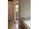 Bathroom featuring tub with marble surround, views through the doorway, and ample storage in the custom cabinets at 870 Thornberry Dr, Alpharetta, GA 30022