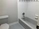 Hall bathroom features tiled walls, gray tub and mosaic trim at 870 Thornberry Dr, Alpharetta, GA 30022