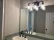 Modern bathroom featuring a sleek vanity, stylish mirror, and contemporary lighting fixture at 870 Thornberry Dr, Alpharetta, GA 30022