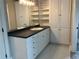 Bathroom boasting white cabinets, a dark countertop, and built-in storage, providing ample space for organization at 870 Thornberry Dr, Alpharetta, GA 30022