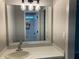 Bright bathroom vanity area with a large mirror, modern lighting, and a clean white countertop at 870 Thornberry Dr, Alpharetta, GA 30022