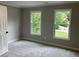 Bedroom showcasing two windows with a view of nature, and neutral paint color throughout the space at 870 Thornberry Dr, Alpharetta, GA 30022