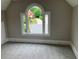 Bedroom showcasing a large arched window with a view of the driveway and front lawn at 870 Thornberry Dr, Alpharetta, GA 30022