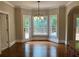 Inviting dining room with beautiful windows, hardwood floors, and elegant chandelier at 870 Thornberry Dr, Alpharetta, GA 30022