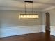 Bright dining area showcasing elegant wainscoting and a modern rectangular chandelier at 870 Thornberry Dr, Alpharetta, GA 30022