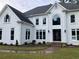 Elegant white two-story home featuring a manicured lawn and beautifully landscaped front yard at 870 Thornberry Dr, Alpharetta, GA 30022