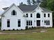 Elegant white two-story home featuring a manicured lawn and beautifully landscaped front yard at 870 Thornberry Dr, Alpharetta, GA 30022