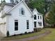 Elegant white two-story home featuring a manicured lawn and three-car garage at 870 Thornberry Dr, Alpharetta, GA 30022