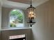View from foyer window, showcasing the neighborhood and a grand chandelier illuminating the space with natural light at 870 Thornberry Dr, Alpharetta, GA 30022
